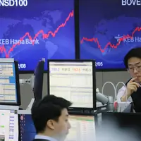 Traders sitting at computer screens