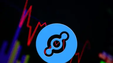 The helium coin logo in front of a price graph