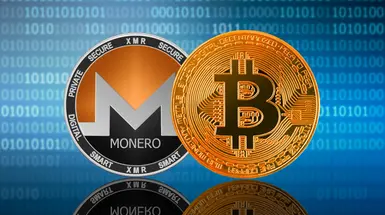 Monero and bitcoin tokens on a blue background