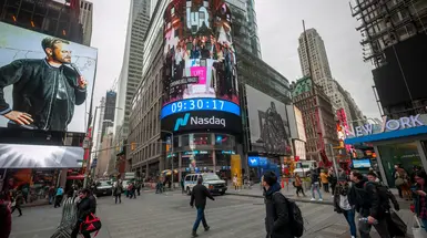 External view of Nasdaq on busy New York street