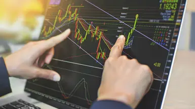 Fingers pointing at a trading chart Fingers pointing at a trading chart