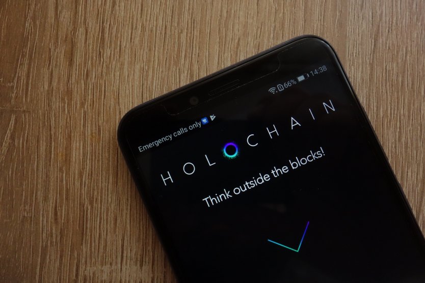 Holochain logo on a smartphone